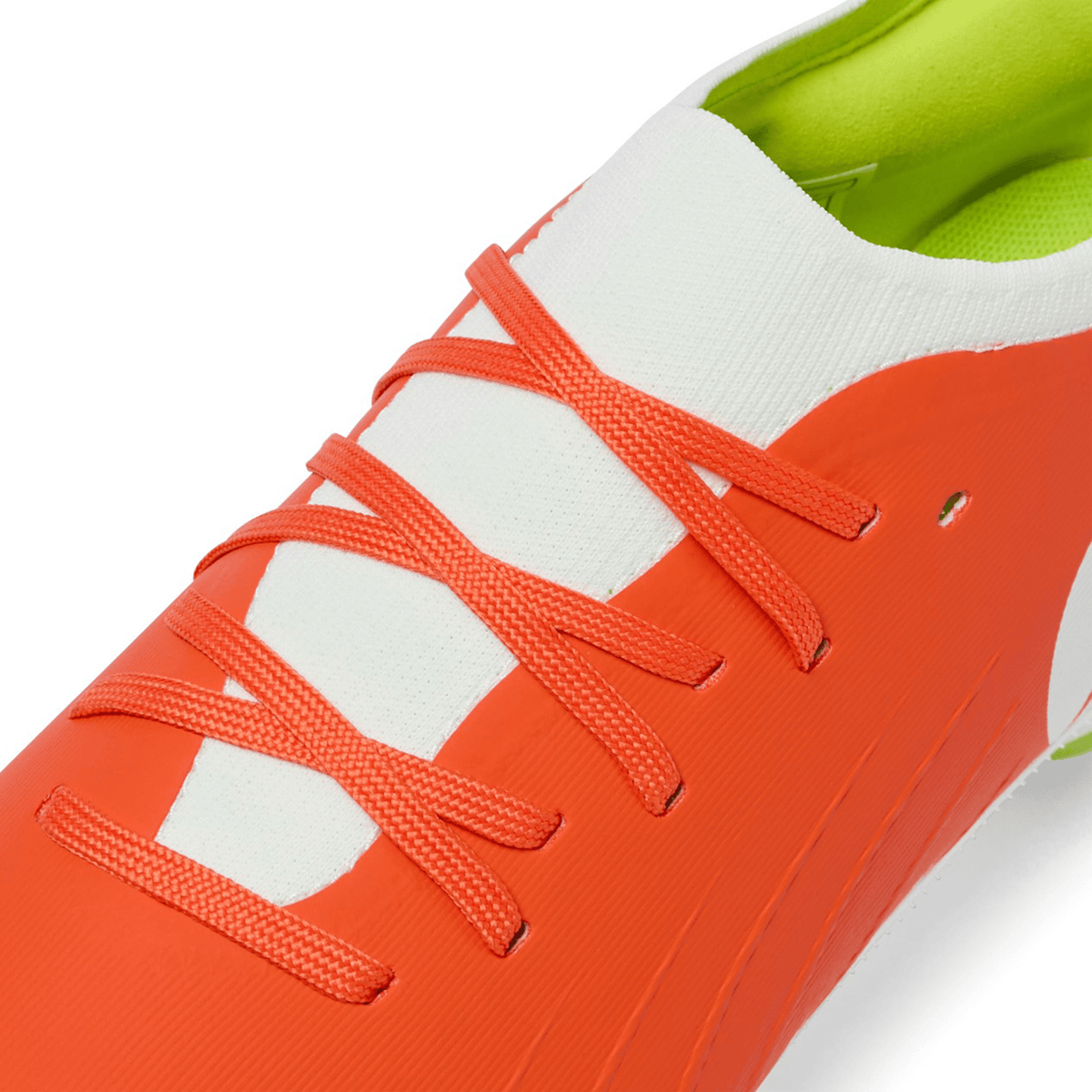 Close-up of Canterbury Speed Falcon Pro SG boots in Tangerine Tango/Snow White, featuring a white tongue, tangerine laces, and a green inner lining—lightweight rugby boots from Canterbury designed for agile performance.