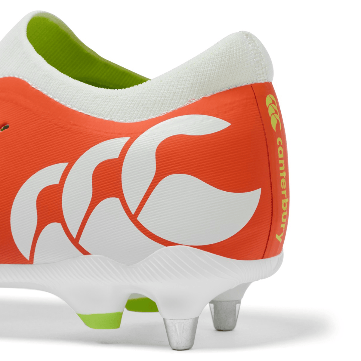 Close-up of the Canterbury Speed Falcon Pro SG boot in Tangerine Tango/Snow White, featuring metal studs and a white logo—lightweight rugby boots from Canterbury designed for soft ground.