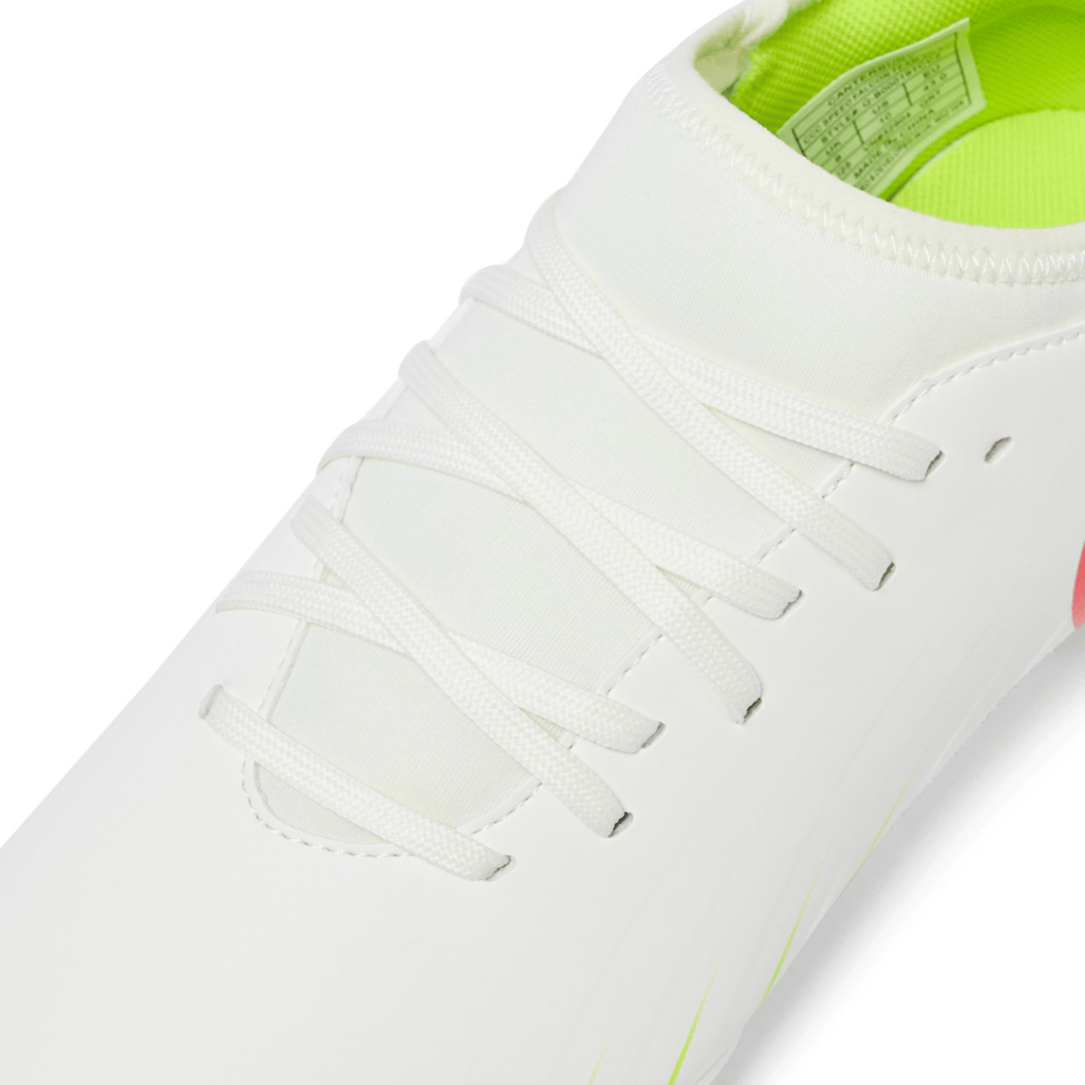 Close-up of the Canterbury Speed Falcon Team SG shoe in Snow White/Tangerine Tango, featuring white laces, a neon green inner lining, and part of the size label—perfect for Canterbury fans.