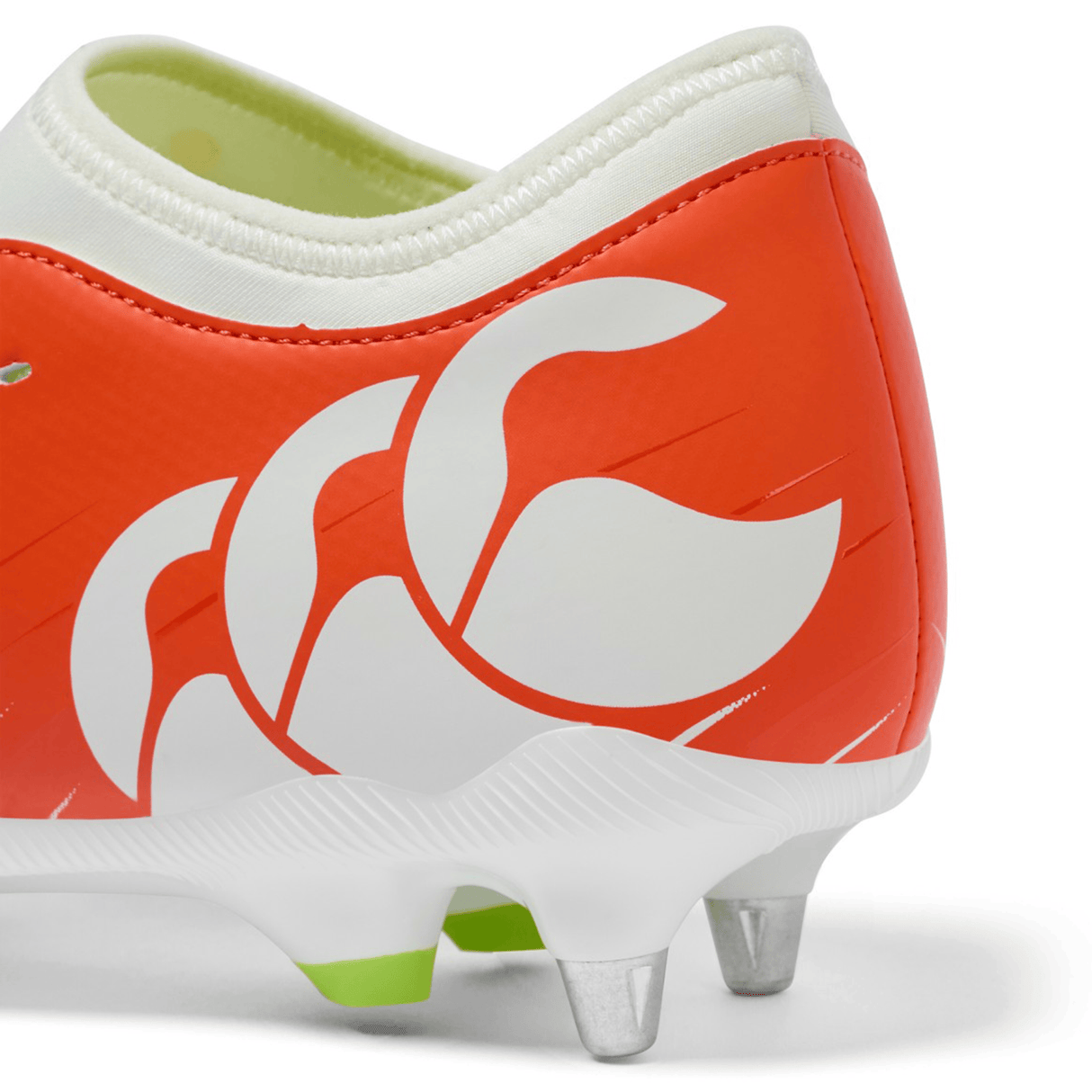 Close-up of the heel of the Canterbury Speed Falcon Team SG rugby boot in Tangerine Tango/Snow White, featuring metal studs and a bold Canterbury logo on the side.