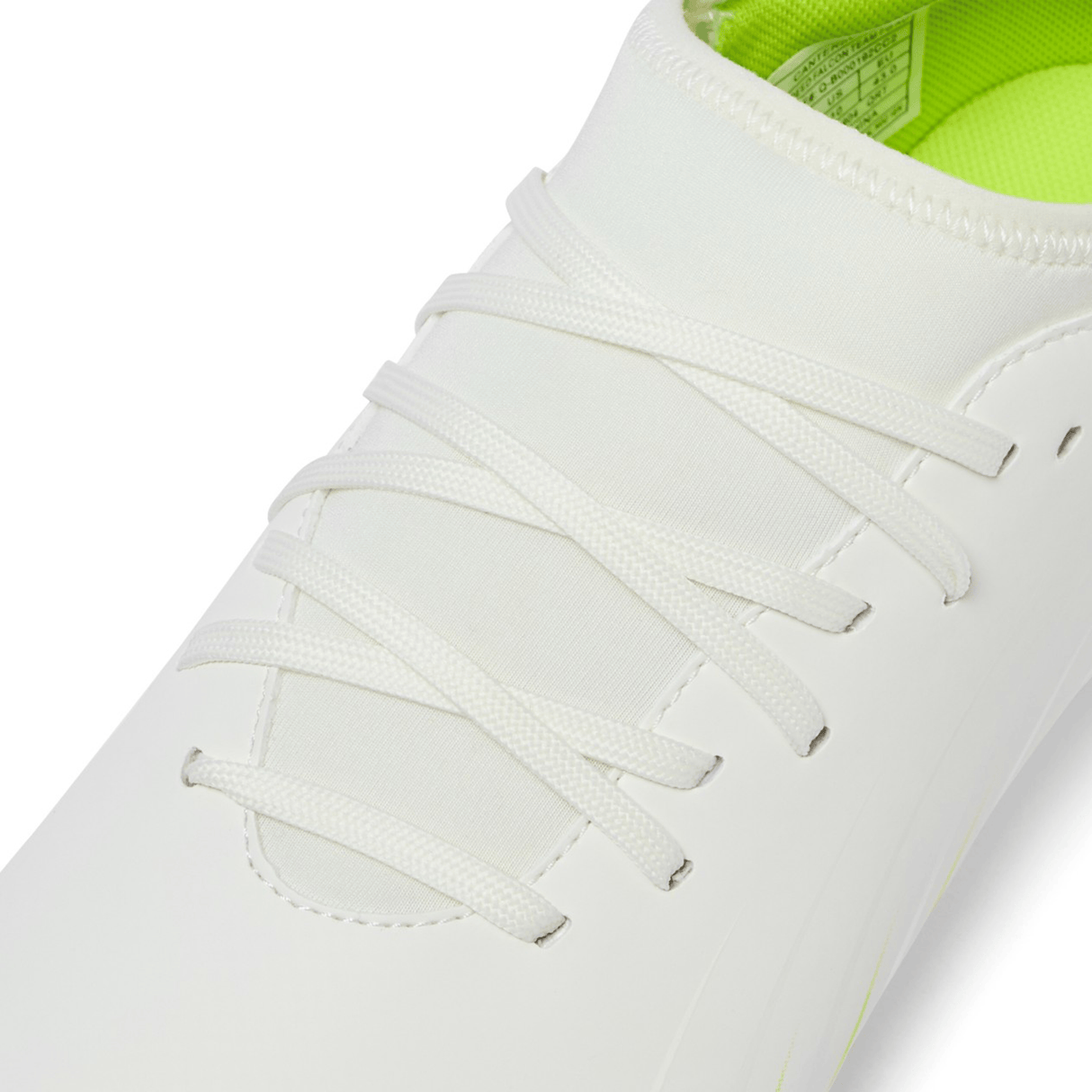 Close-up of the Canterbury Speed Falcon Team FG in Snow White/Tangerine Tango, featuring white laces and a light green inner lining.