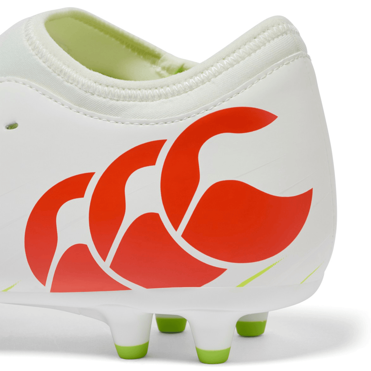 Close-up of the heel of the Canterbury Speed Falcon Team FG soccer cleat in Snow White/Tangerine Tango, showing a red logo, green-tipped sole studs, and a Tangerine Tango accent.