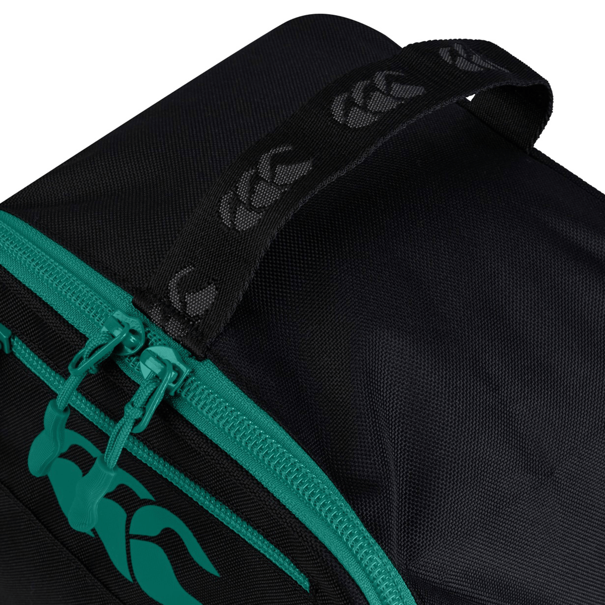 Close-up of the Ireland 25/26 Bootbag by Canterbury, showcasing teal zippers, a bold teal logo, and a sturdy black handle with repeating logo pattern—ideal for carrying your rugby boots in style.