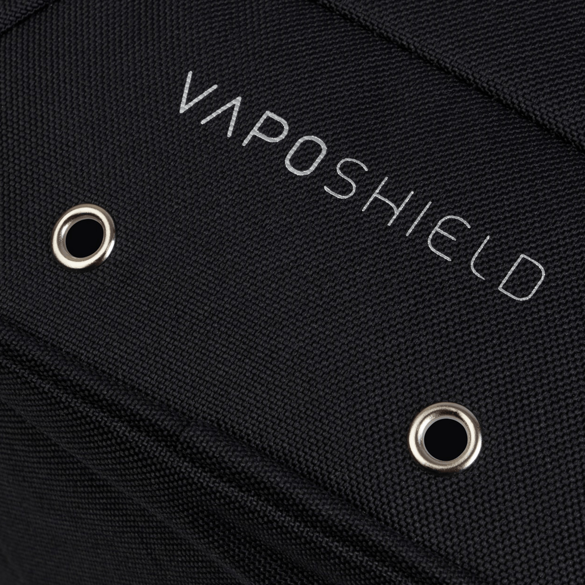 Close-up of the black fabric surface on the Ireland 25/26 Bootbag by Canterbury, featuring "VAPOSHIELD" branding and two circular metal eyelets.