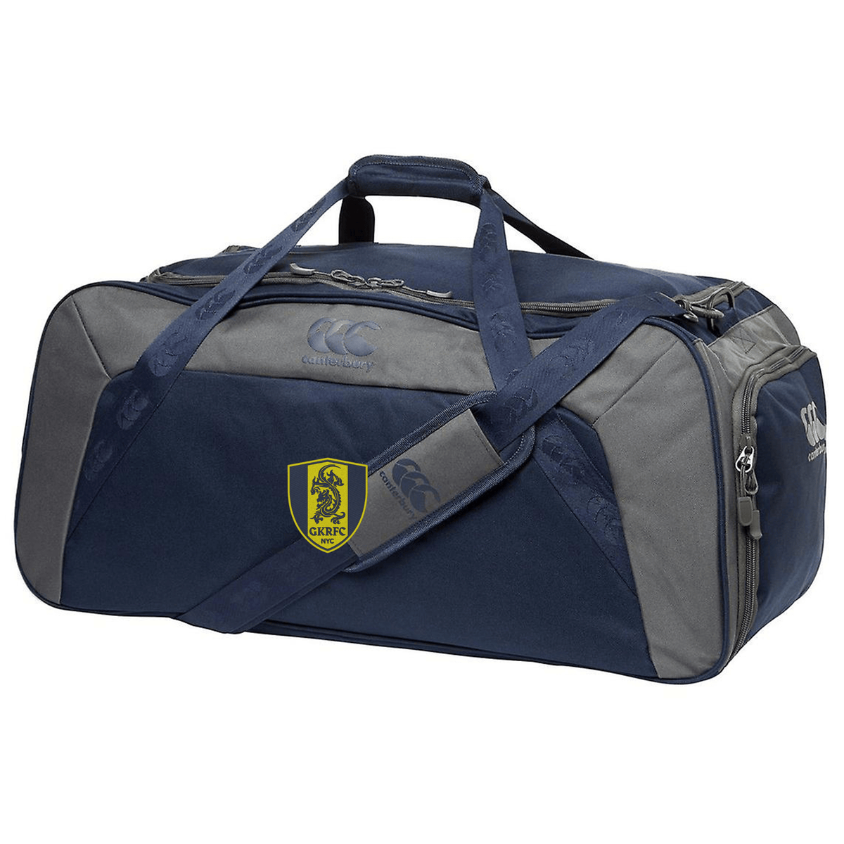 Description: The Gotham Knights Holdall Duffle Bag by Canterbury from EMB Canterbury features a blue and grey design with dual handles, an adjustable padded shoulder strap, multiple zippers, and a yellow and black crest logo on the side.