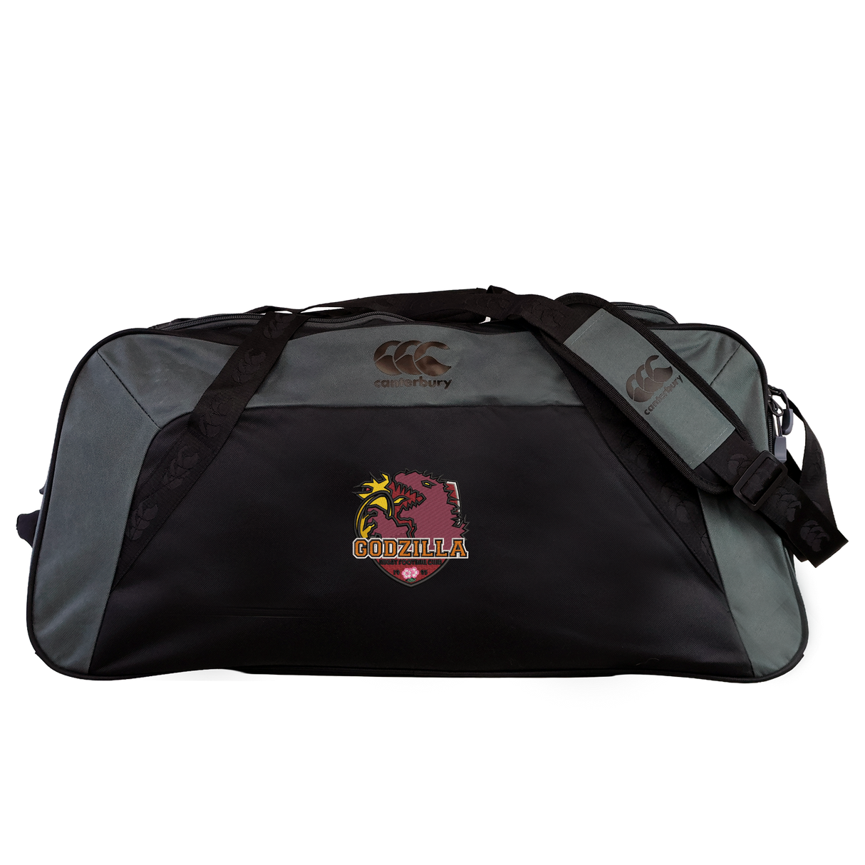 The Godzilla Rugby Football Club Holdall Duffle Bag by Canterbury, from EMB Canterbury, is a black and gray water-repellent duffle bag featuring a striking Godzilla logo and the word “GODZILLA” across the front, topped with the iconic Canterbury logo. This stylish holdall offers durability and an attention-grabbing design—perfect for rugby players on the go.