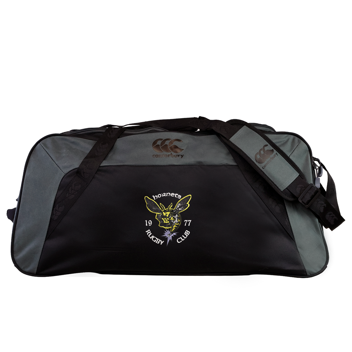 The Hornets Rugby Club 1977 Holdall Duffle Bag by EMB Canterbury is a large black and gray sports bag featuring the “Hornets Rugby Club 1977” logo and a yellow hornet emblem on the front pocket. This water-repellent holdall includes an adjustable shoulder strap for comfortable carrying.