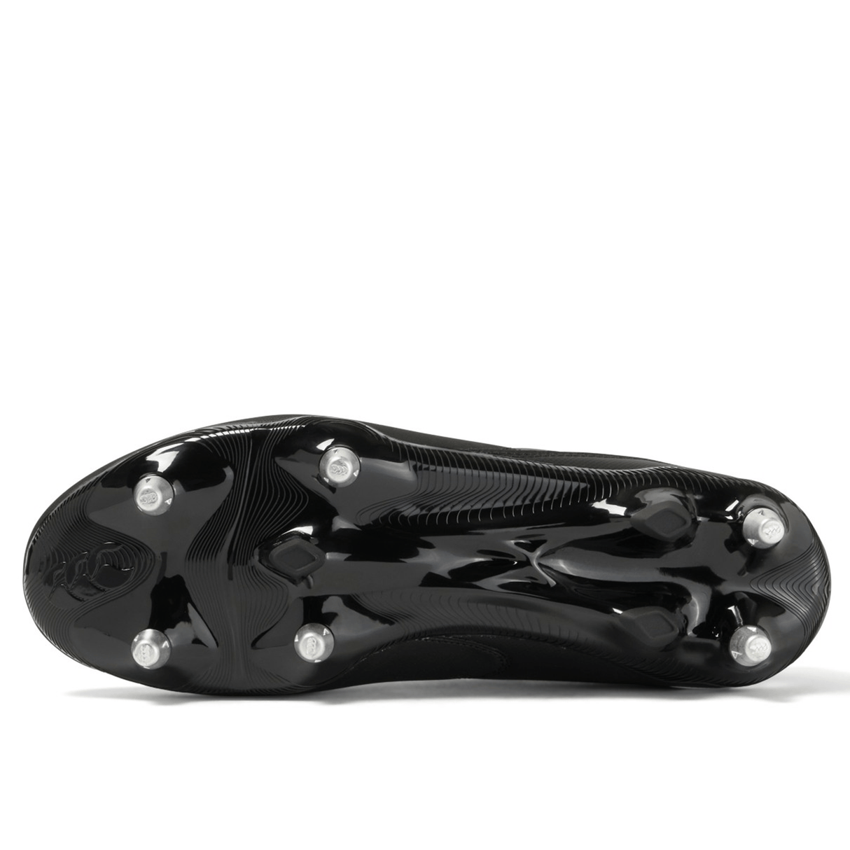 The bottom view of a black and white Canterbury Phoenix Raze SG Boot, featuring high-traction metal studs for optimal performance on soft ground.