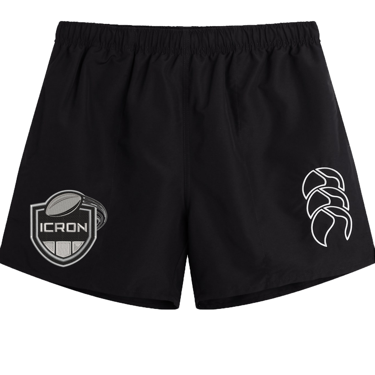 Black ICRON Tactic Short by Canterbury with an elastic waistband, featuring a shield-shaped emblem on the left leg and a logo on the right.