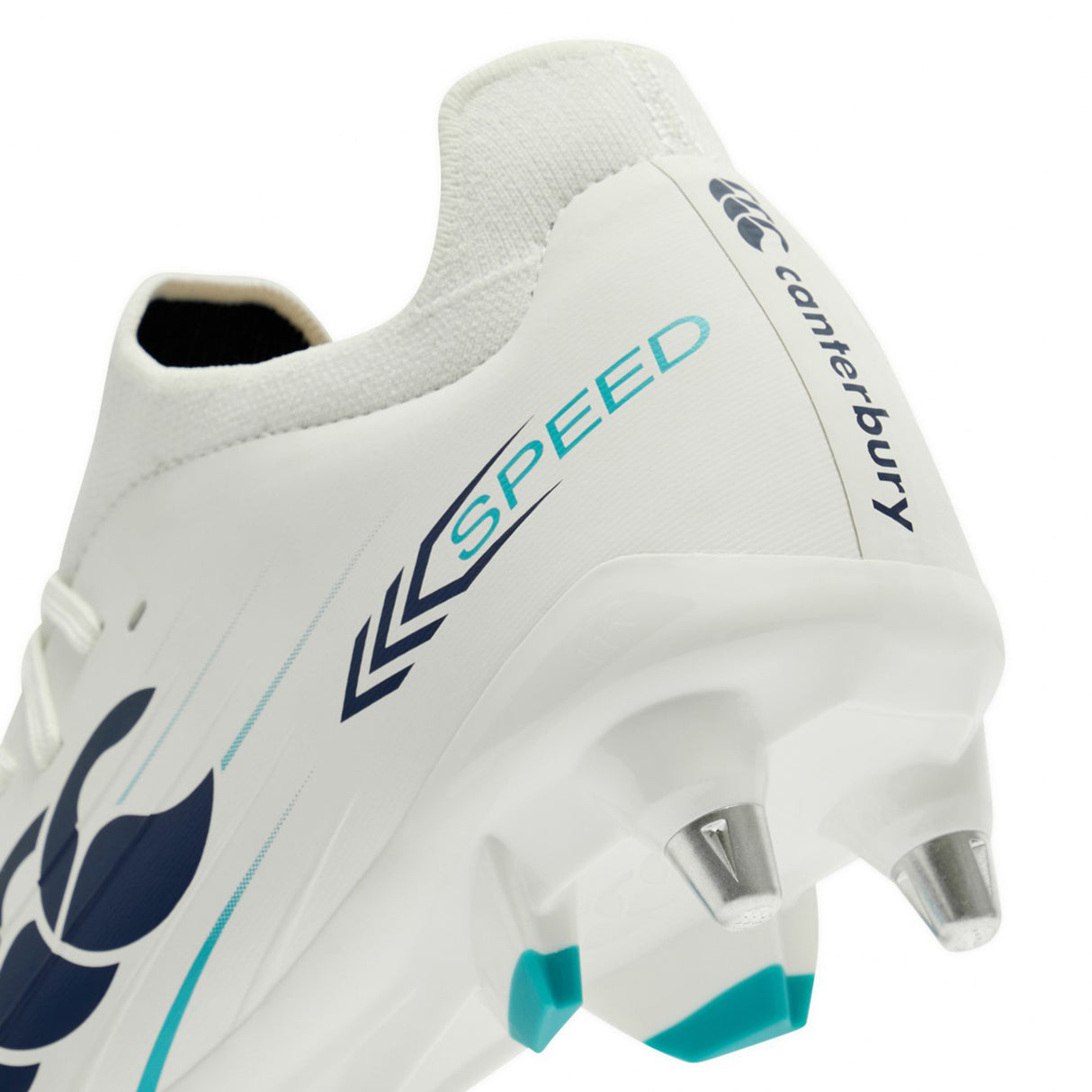 Close-up of the heel and studs of the Canterbury Speed Falcon 2.0 Pro SG rugby boots in White/Baltic Green, featuring “SPEED” and the Canterbury logo in blue—highlighting their lightweight construction designed for top soft ground performance.
