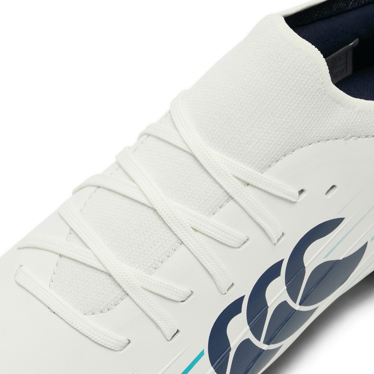 Close-up of the Canterbury Speed Falcon 2.0 Pro FG in White/Baltic Green, featuring white laces, a Baltic Green and navy blue design on the side, and a smooth upper material engineered for lightweight performance inspired by top-tier rugby boots.