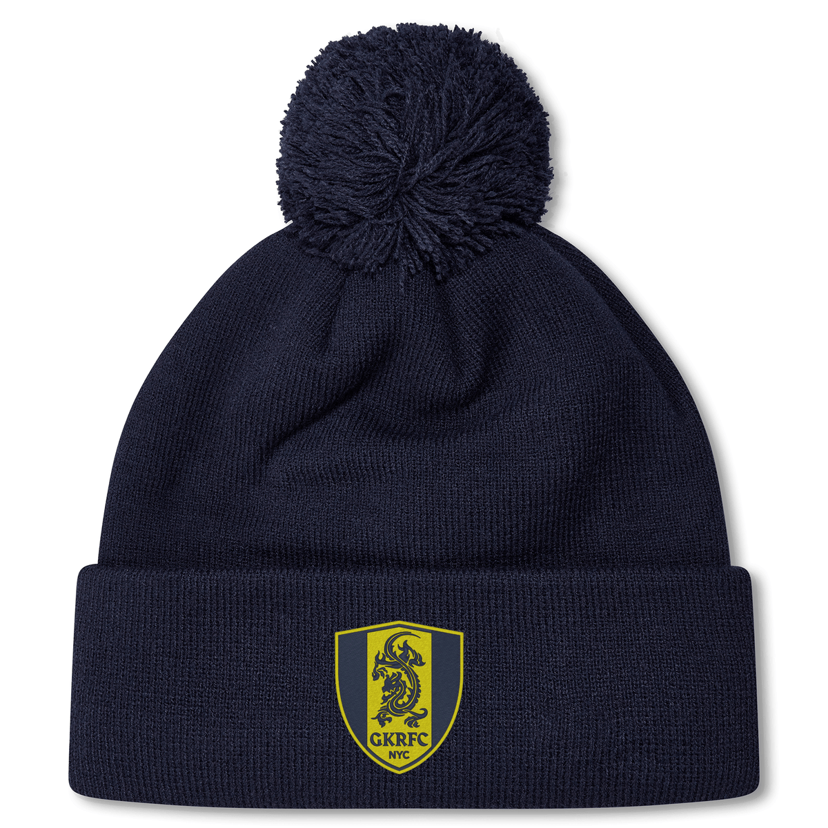 The Gotham Knights Pom Pom Beanie by Canterbury from EMB Canterbury is a stylish navy blue knit beanie with a pom-pom on top. It features a yellow and blue shield logo with a dragon and the text "GKRFC NYC." This rugby hat is perfect for keeping warm on cold days out on the field.