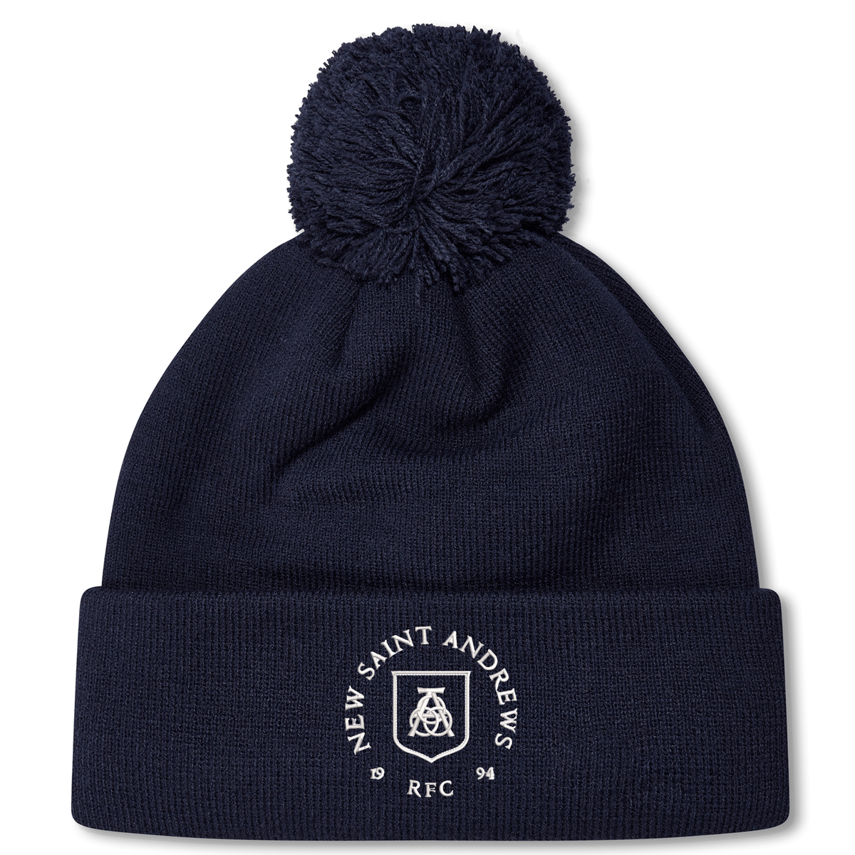 Introducing the New Saint Andrews College Pom Pom Beanie by Canterbury: a navy blue knit beanie with a playful pom-pom on top, featuring the white New Saint Andrews RFC logo embroidered on the cuff. Brought to you by EMB Canterbury.