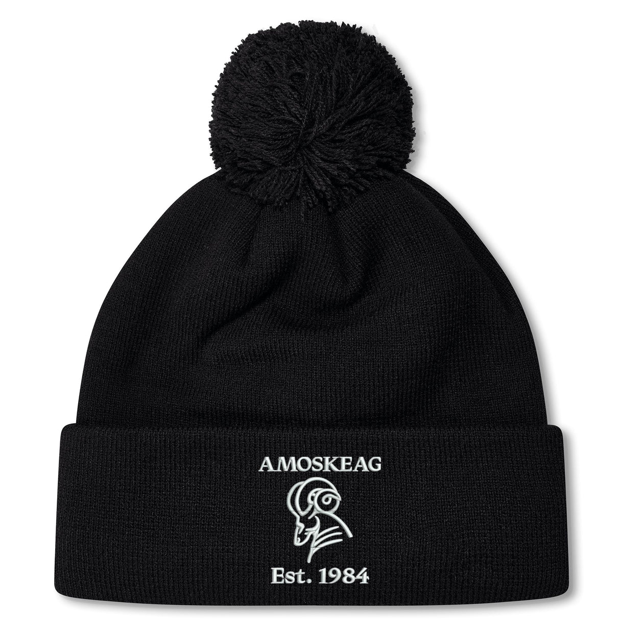 The Amoskeag Rugby Club Pom Pom Beanie by EMB Canterbury is a black knit hat with a folded brim, featuring “AMOSKEAG,” a ram logo, and “Est. 1984” embroidered in white.