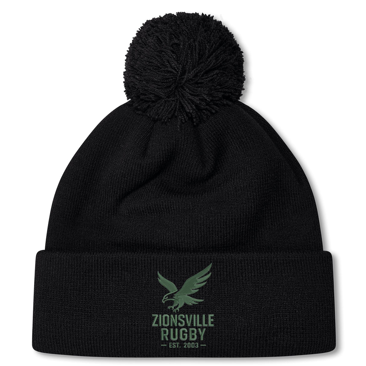 The Zionsville Rugby Club Pom Pom Beanie by EMB Canterbury is a black knit hat with a green eagle and "Zionsville Rugby Est. 2003" on the front cuff, soft fleece lining, and classic pom-pom for added warmth.