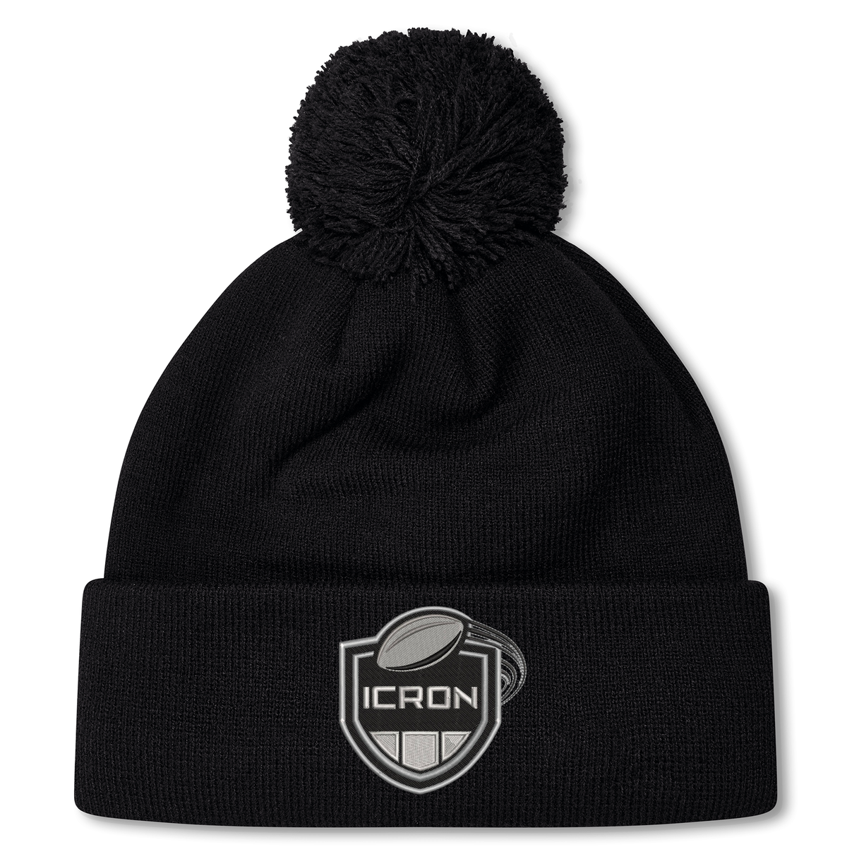 Black ICRON Pom Pom Beanie by Canterbury, featuring a pom pom and a patch with a rugby ball above the word “ICRON.”