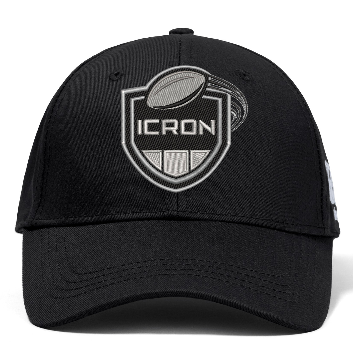 Black ICRON Flexfit Drill Cap by Canterbury with a curved brim and an embroidered shield emblem featuring a rugby ball and the word “ICRON.”