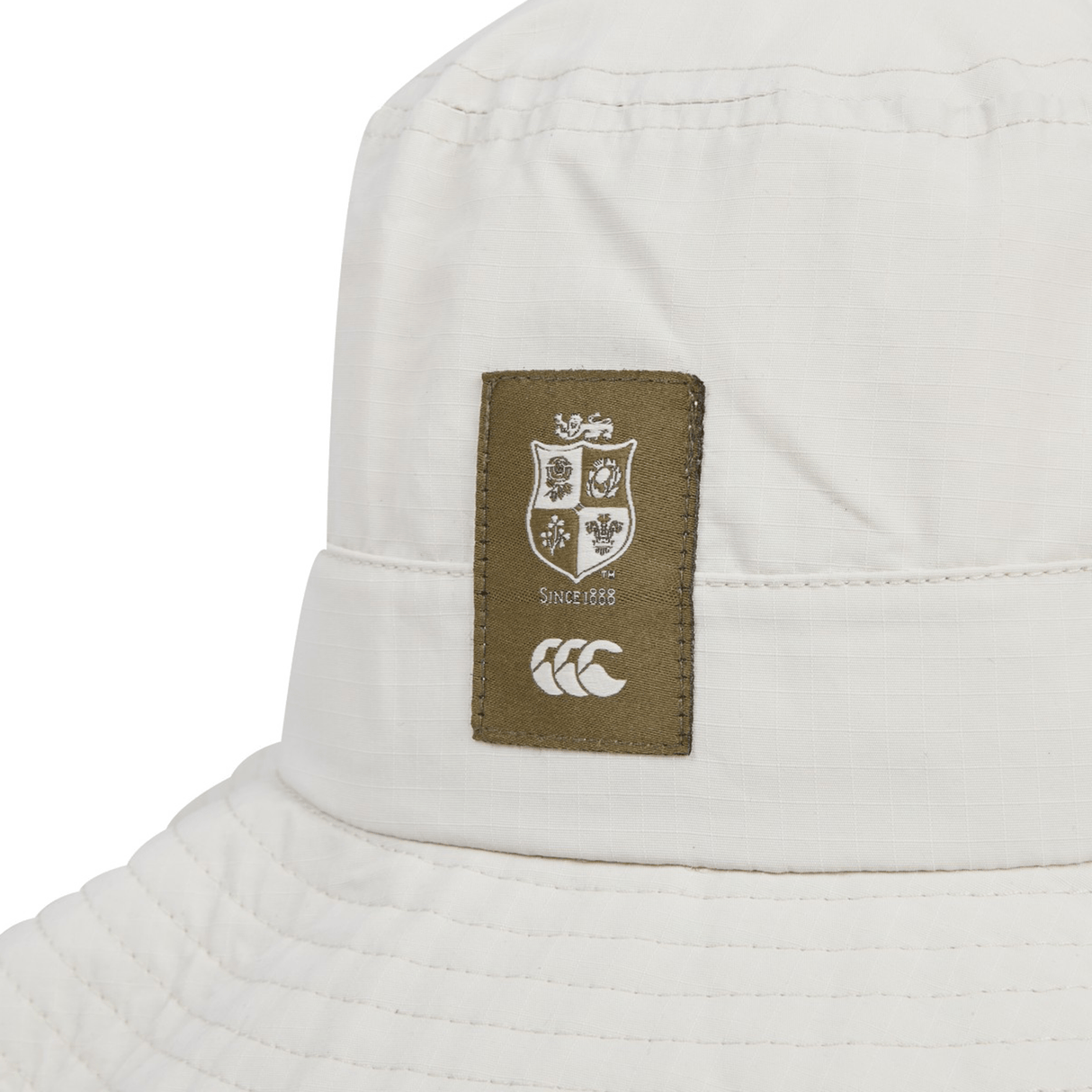 Here's a close-up of the British & Irish Lions 2025 Outback Wide Brim Bucket Hat by Canterbury. Crafted from quick-dry ripstop polyester, it features a distinctive brown patch with a shield design and "Since 1888" beneath which adds a stylish touch for fans seeking both practicality and flair.