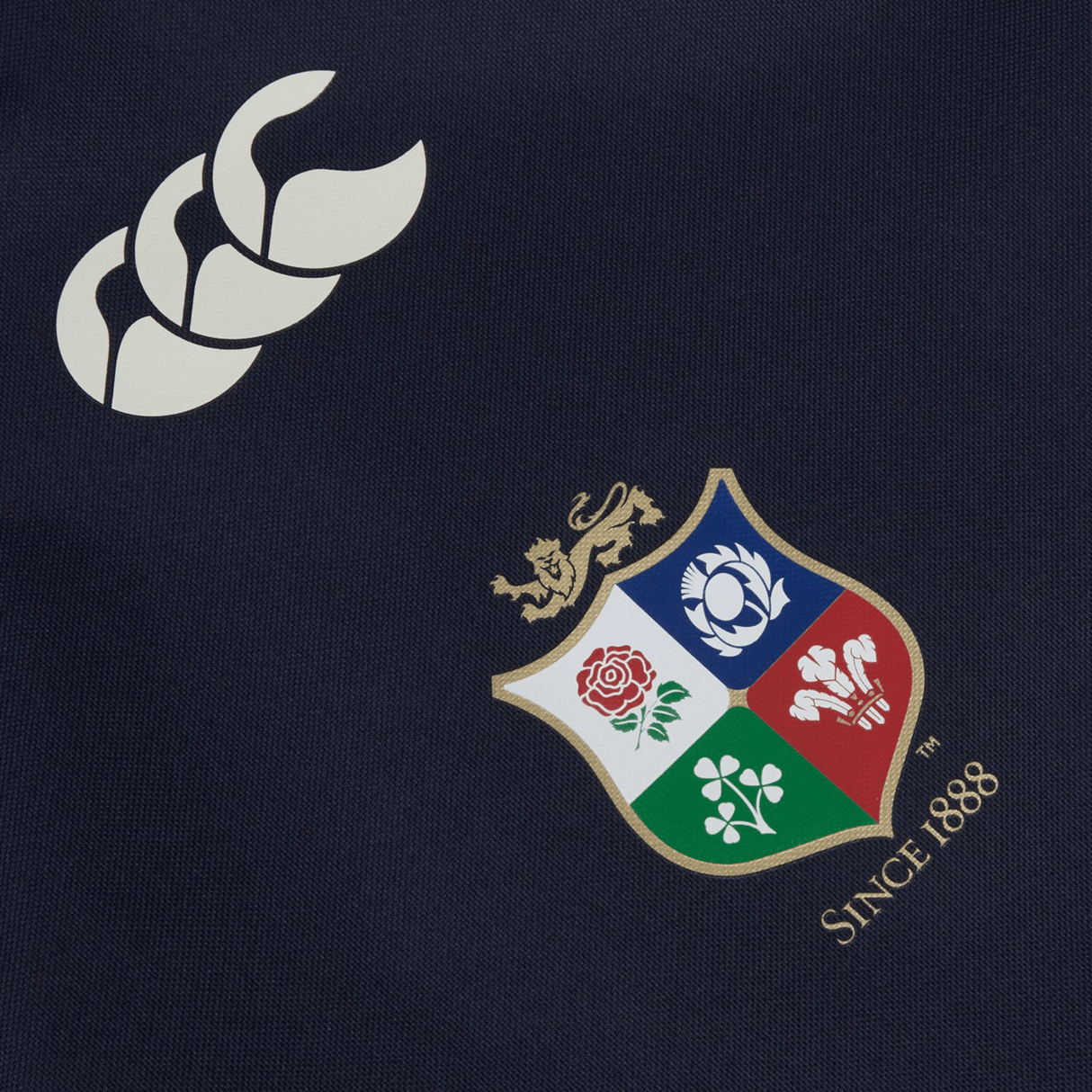The British & Irish Lions 2025 Gym Sack by Canterbury, made from navy blue fabric, features a bold white logo with three stylized leaves and a multicolored shield bearing four emblems, crowned by a lion. It prominently displays the text "SINCE 1888," echoing the tradition of the British & Irish Lions.