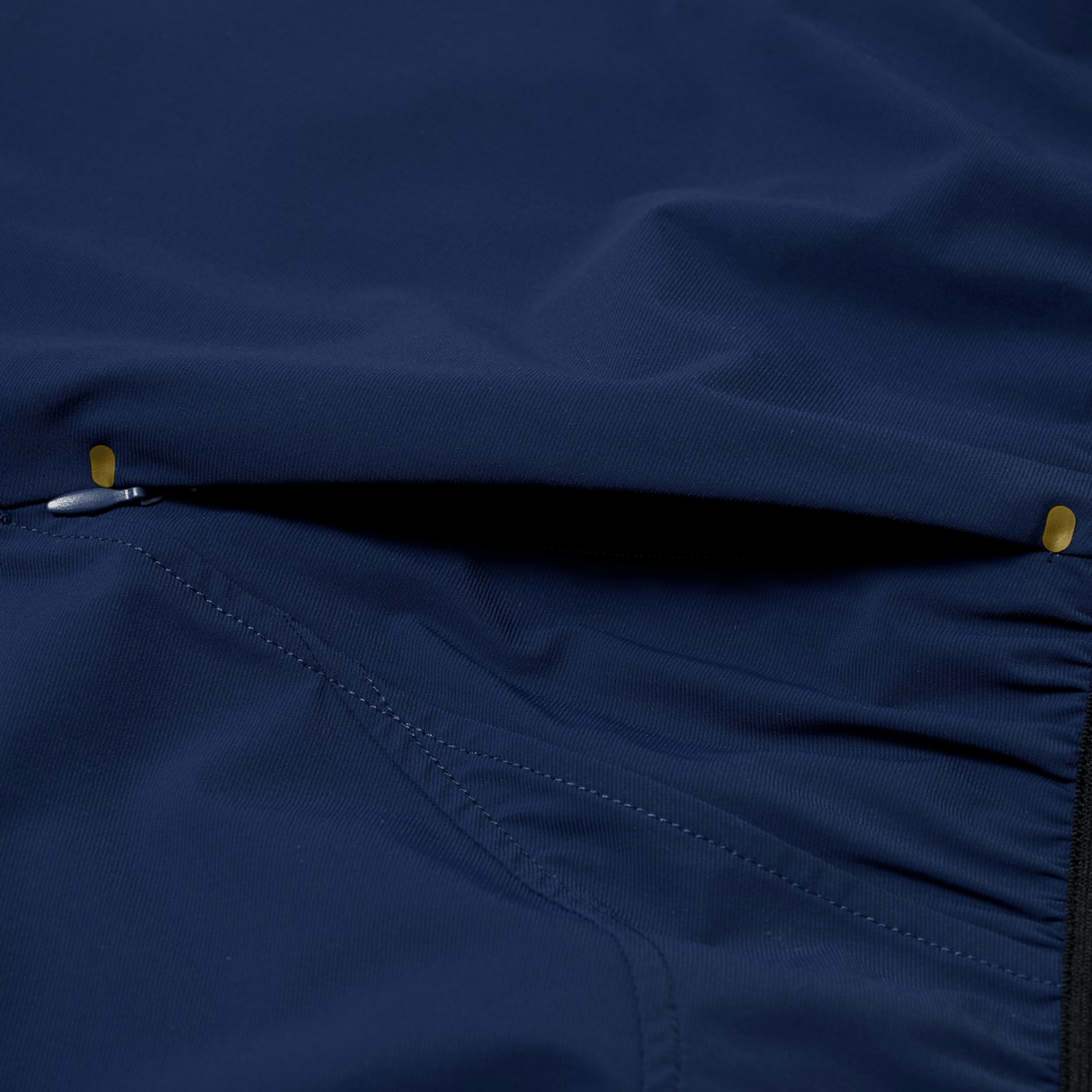 Close-up of a zippered pocket on the Canterbury Everest Woven Short 5", highlighting stitching, small metal rivets, and breathable wicking fabric that makes these Canterbury shorts ideal for workouts.