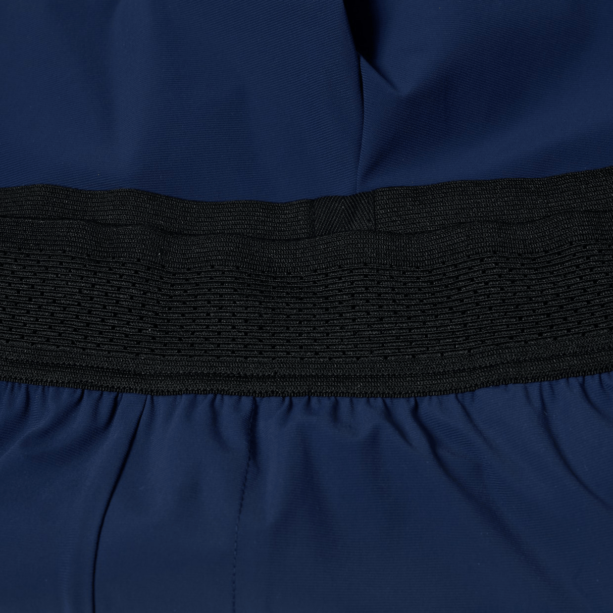 Close-up of the Canterbury Everest Woven Short 5" in navy blue, with a wide black elastic band and breathable wicking fabric—ideal for gym wear.