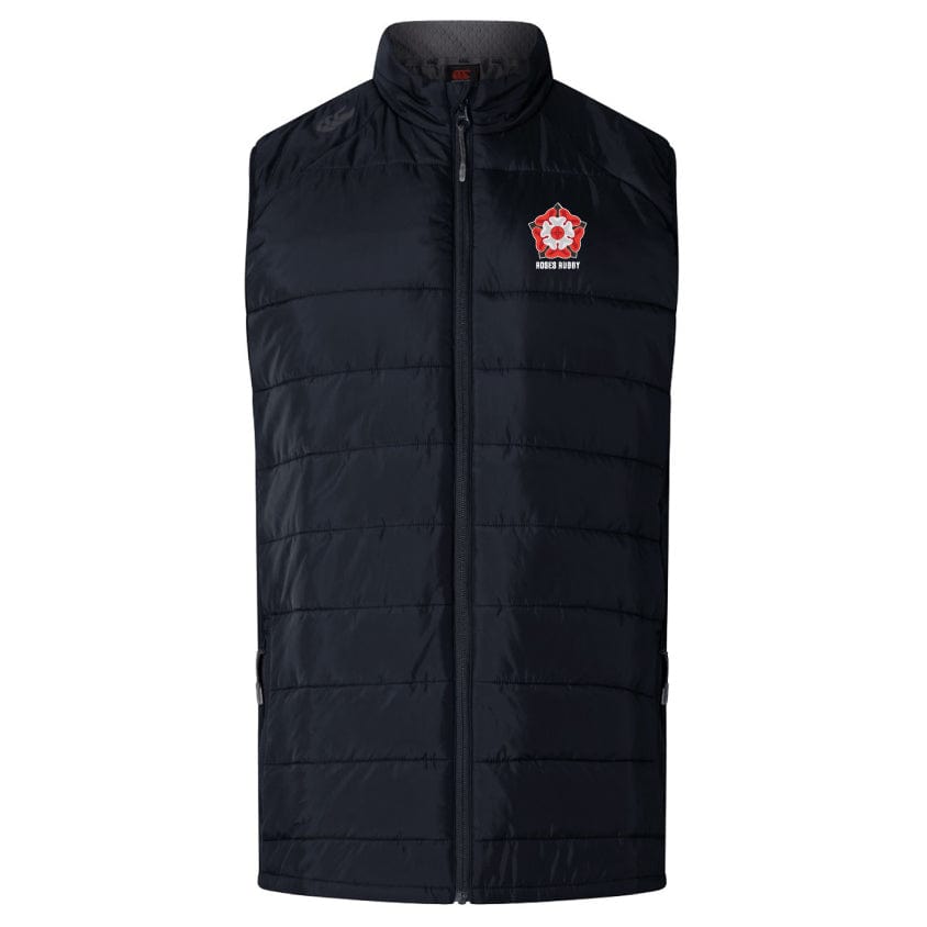 Discover the Roses Rugby Elite Microlite Gilet by Canterbury. This black padded vest features insulated baffles, a high collar, and a zipper closure. It showcases a red and white logo on the chest, offering style and warmth for any weather. From EMB Canterbury.