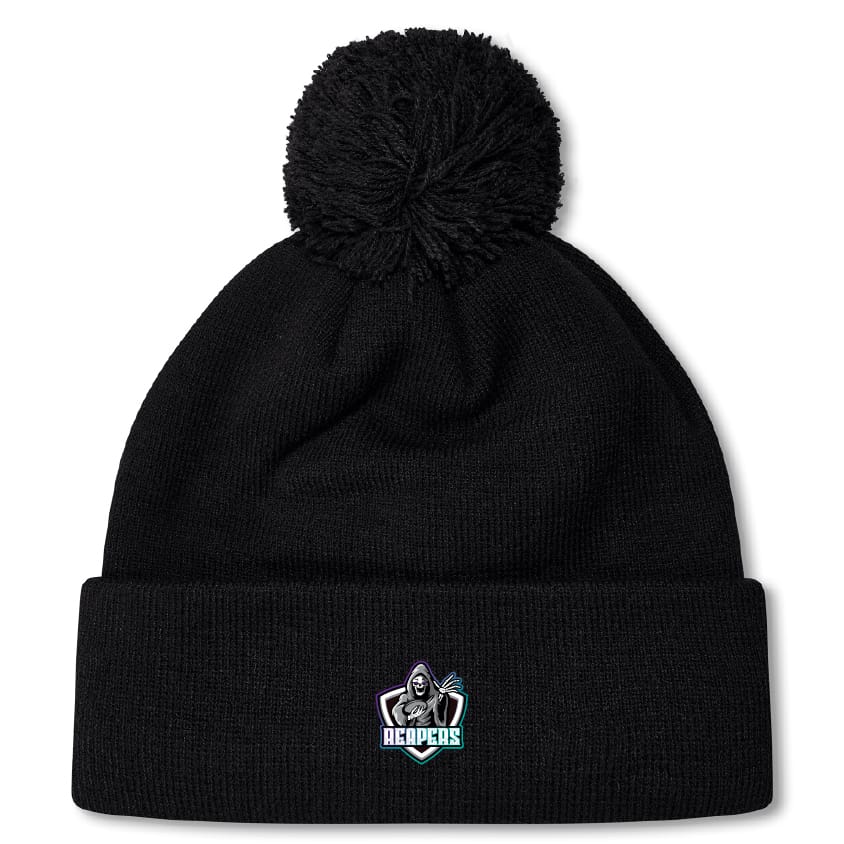 The South Reapers Pom Pom Beanie by EMB Canterbury is a black knit hat with a pom-pom, fleece lining for warmth, and an embroidered hooded figure with "REAPERS" text on the front cuff.