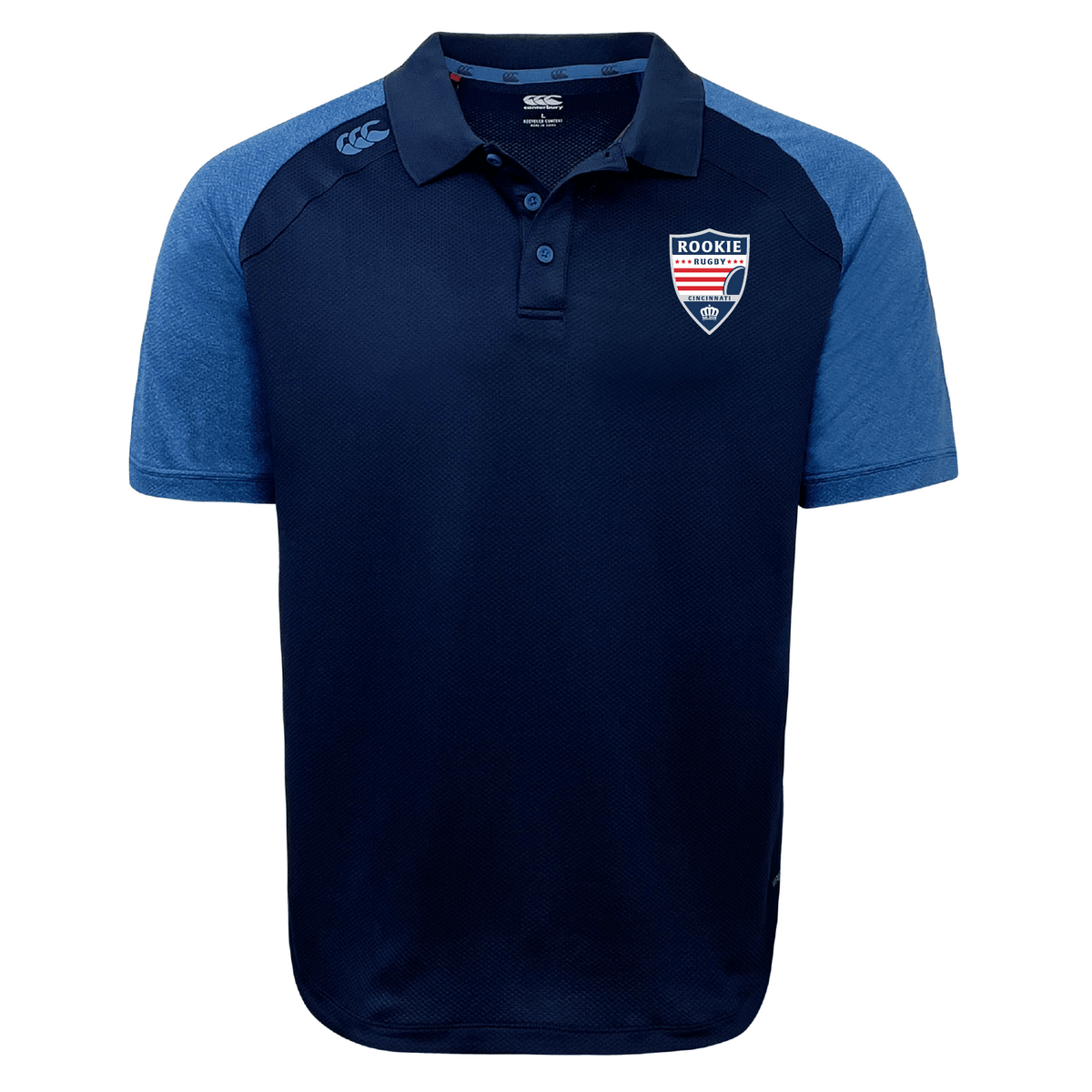 Navy blue Cincinnati Rookie Rugby Elite Polo with a polo collar, featuring a red and white "rookie" badge on the left chest and a small EMB Canterbury logo on the right.
