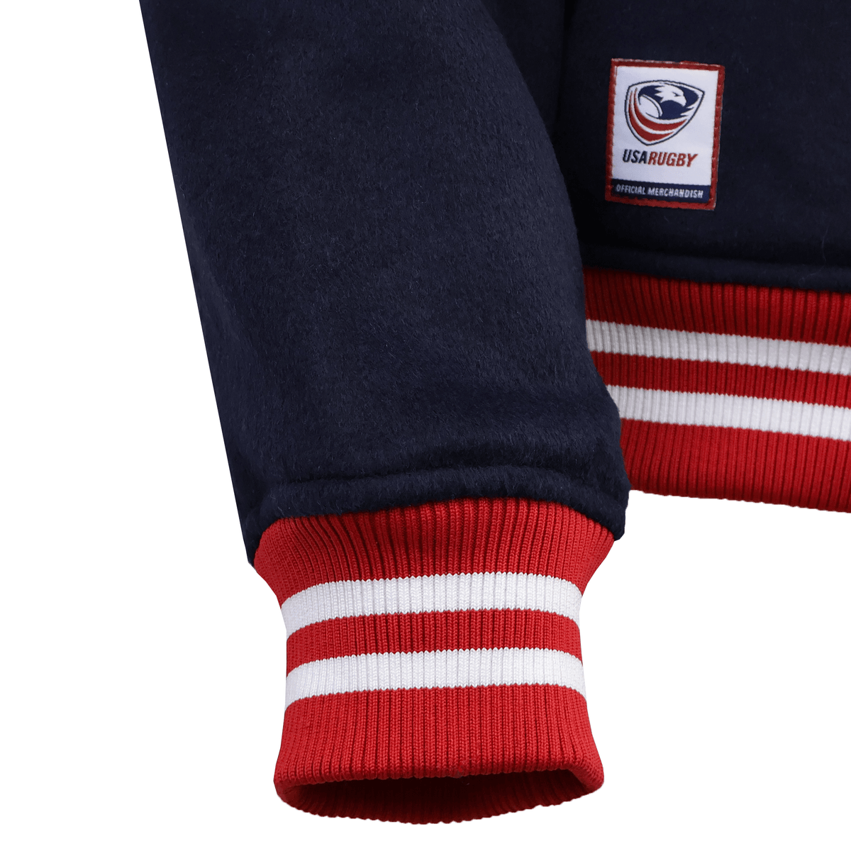 Close-up of an SDS USA Rugby Varsity Wool Jacket sleeve featuring red and white striped cuffs and a USA Rugby patch on the front.