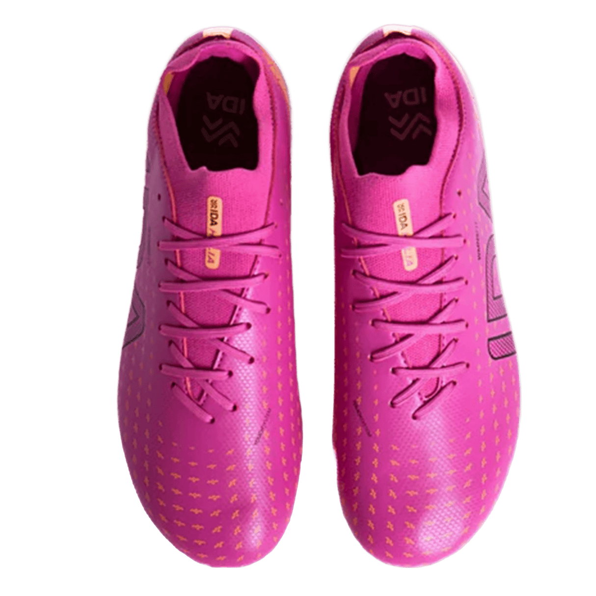 A pair of IDA Helia Club SG soccer boots by IDA Sports in dark pink with yellow accents, viewed from above, show "IDA" branding on the insoles and patterned detailing on the toes.