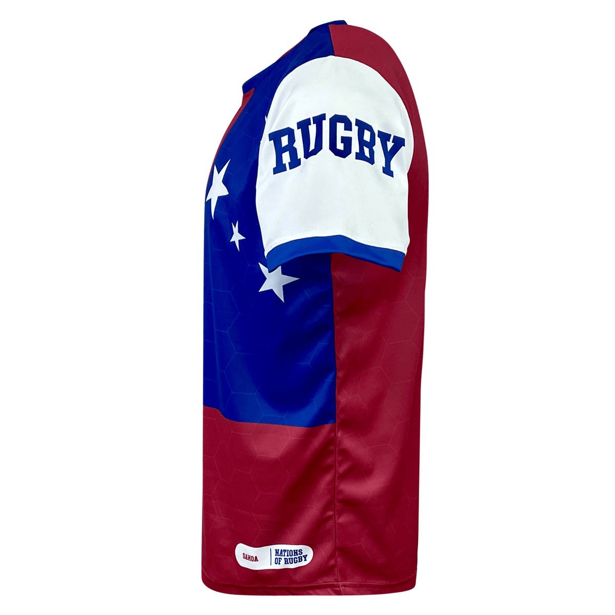 Side view of an Admiral Nations of Rugby Samoa Sevens Rugby Flag Jersey with red and blue panels, white sleeve with "RUGBY" printed, and stars on the blue panel. The bottom of the jersey features a "Nations of Rugby" label. Crafted with VapoDraw technology, it's perfect for any Samoa Sevens supporter.