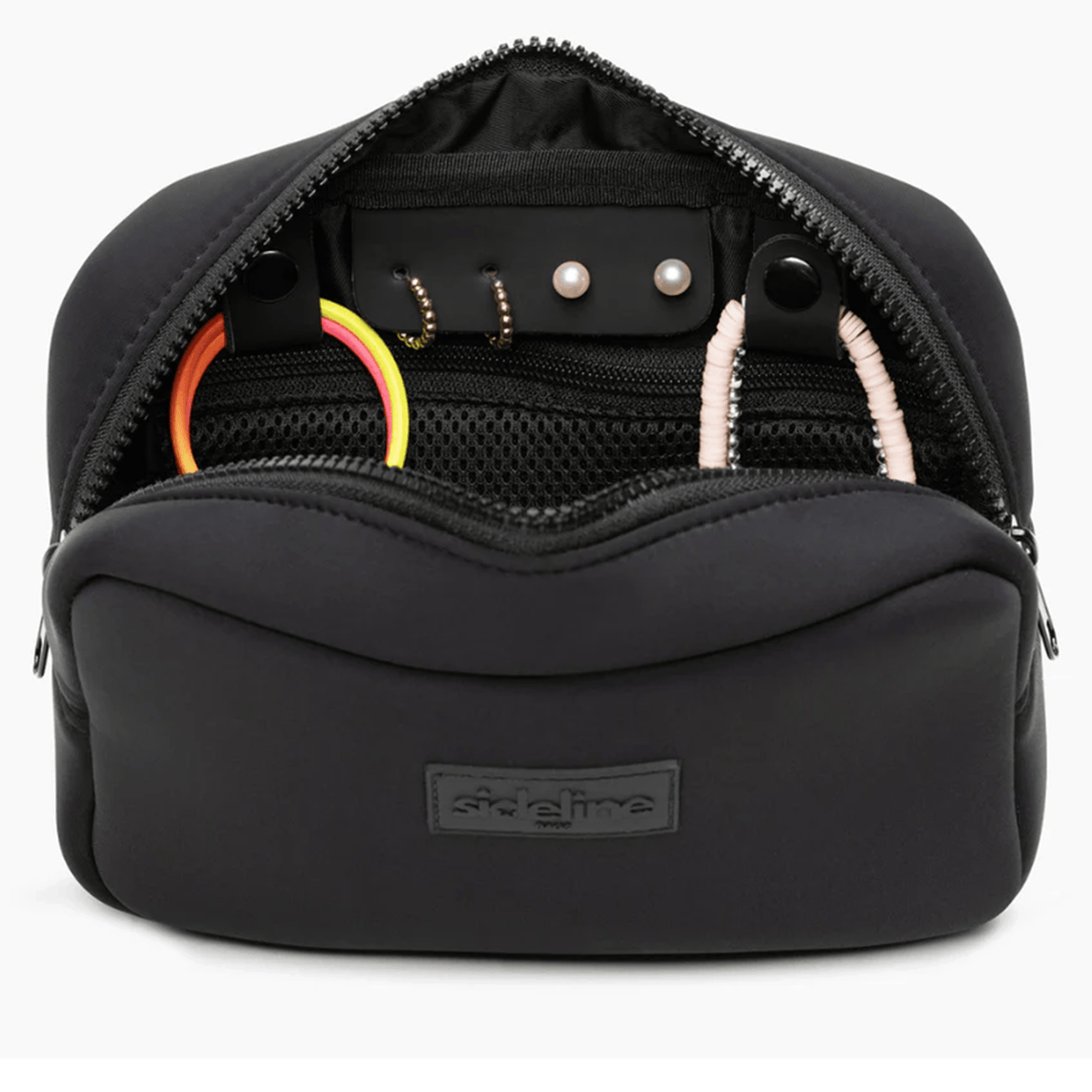 The Original Side Line Bag by SLB is a black waterproof neoprene organizer for female athletes, with a front "sideline" logo patch, open to display organized hair ties, earrings, and a mesh pocket inside.