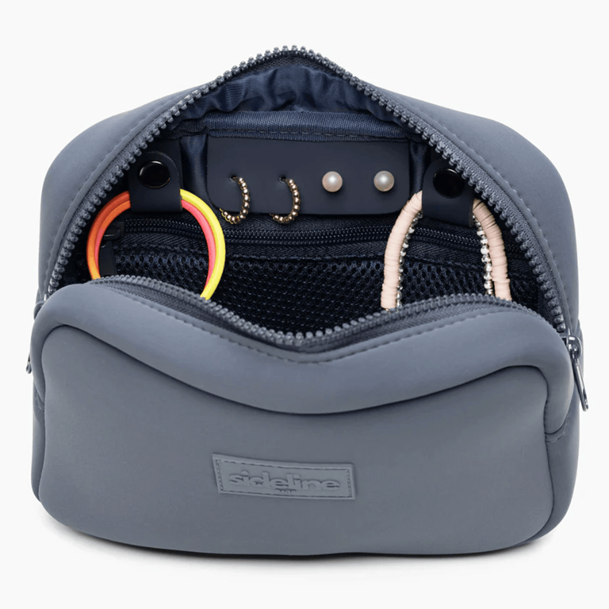 The SLB Original Side Line Bag is a grey waterproof neoprene organizer that unzips to reveal hair ties, beaded accessories, and small hoop earrings—ideal for female athletes to keep essentials neatly arranged.