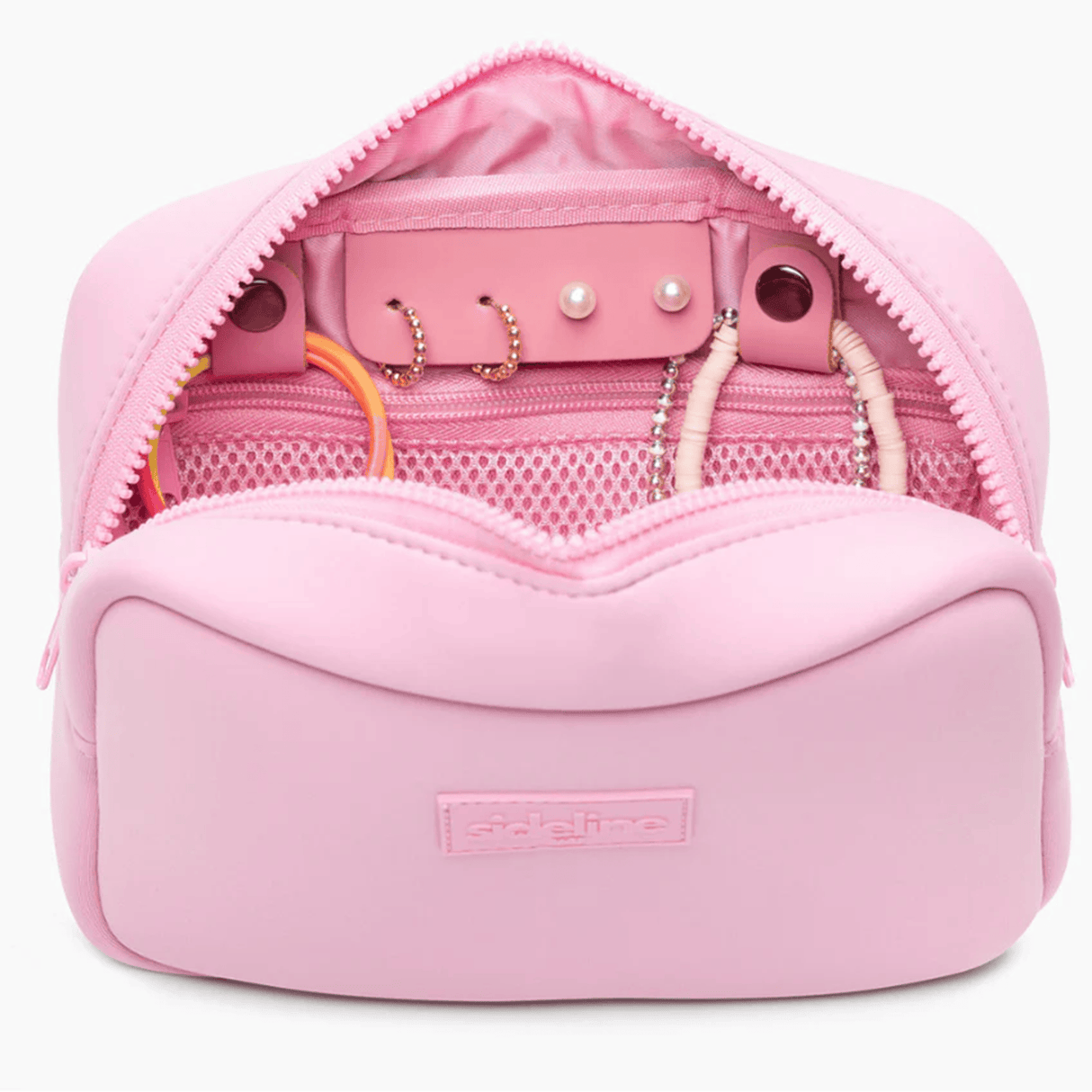 The Original Side Line Bag by SLB is a light pink waterproof neoprene organizer, shown open with hoop earrings, a beaded bracelet, bangle, and pearl studs in compartments—perfect for female athletes to store jewelry.