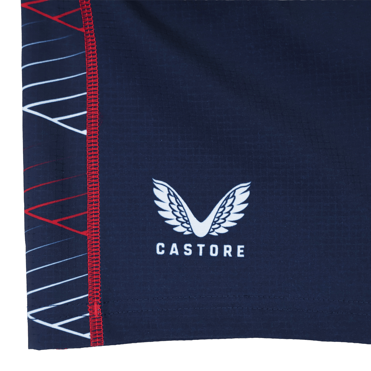 Close-up of a navy blue fabric with the Castore logo and white/red geometric lines, from the Women's USA Rugby 22/23 7s RWC Away Pro Short by Castore.