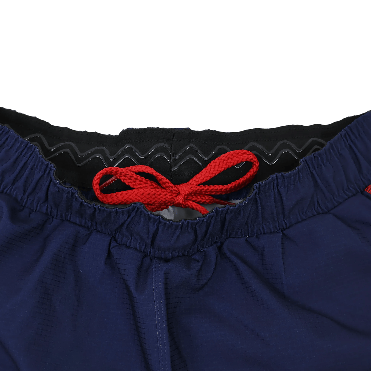 Close-up of the waistband on the Castore Women's USA Rugby 22/23 7s RWC Away Pro Short, showing a red drawstring and black inner lining, set against a white background.