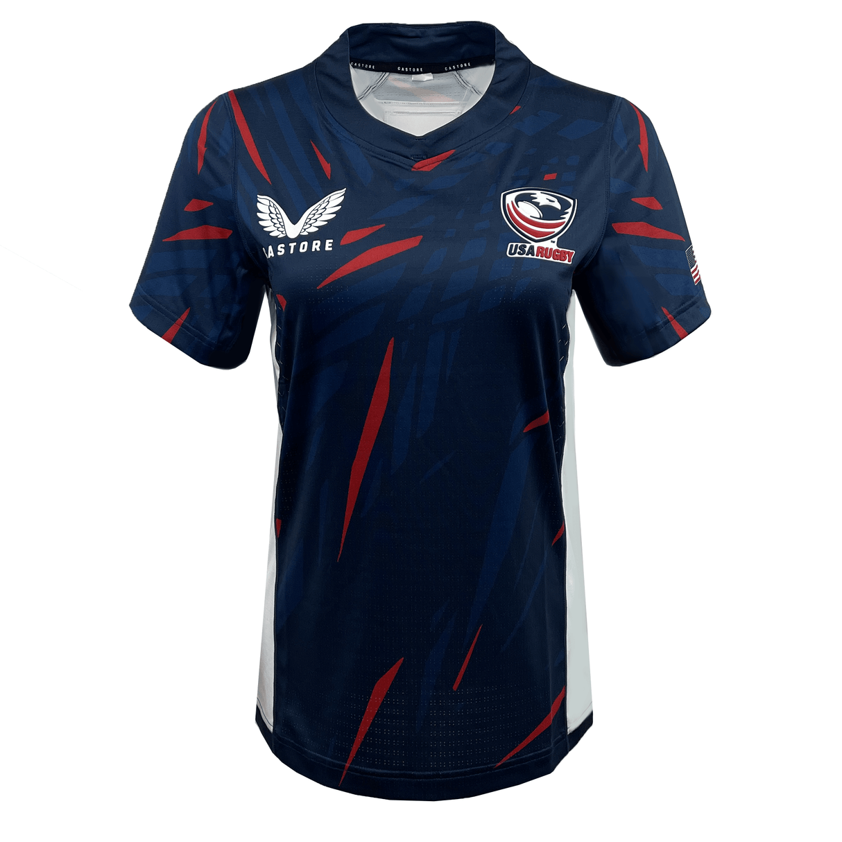 The Women's USA Rugby 23/24 Pro Home Jersey by Castore features a navy blue design with red and blue diagonal streaks, short sleeves, and Castore and USA Rugby logos on the chest.