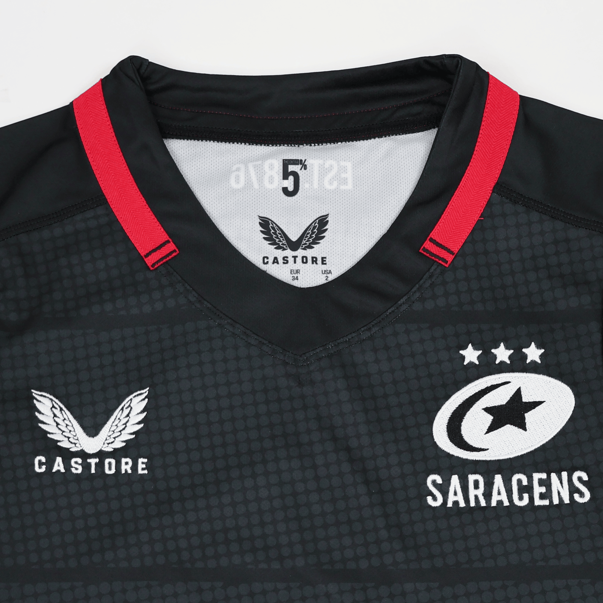 The Women's Saracens 24/25 Home Replica Jersey by Castore features a bold red collar, Castore logo on the left, and Saracens team logo with stars on the right—a stylish rugby jersey for devoted fans.