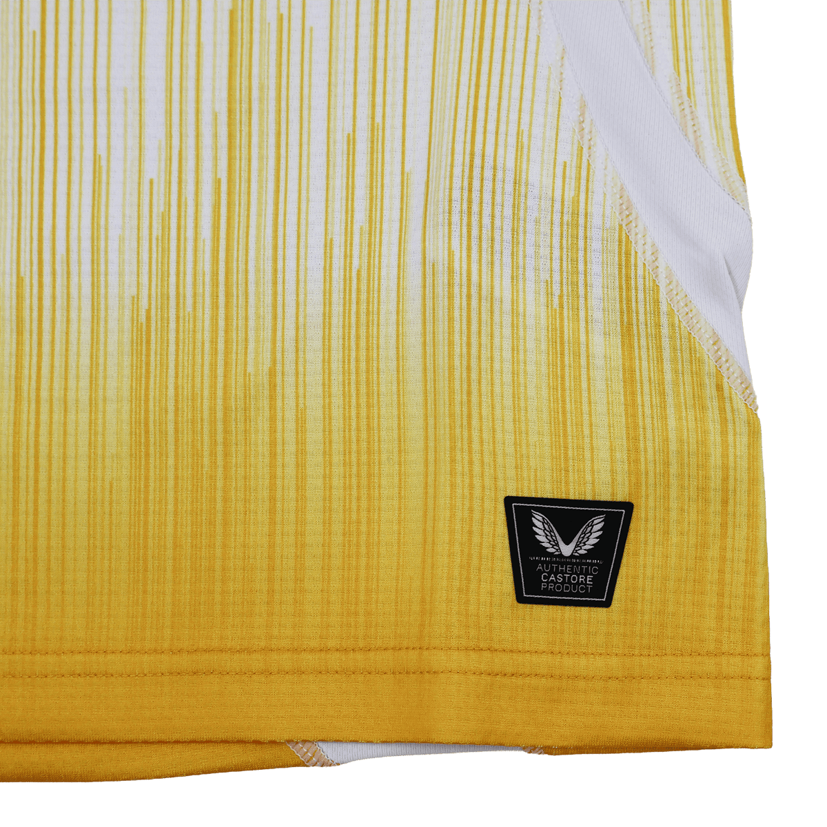 Close-up of the Leinster 25/26 Away Pro Shirt by Castore, a yellow and white jersey with vertical gradient lines, black patch label on the lower hem, and crafted from high-performance technical fabric.