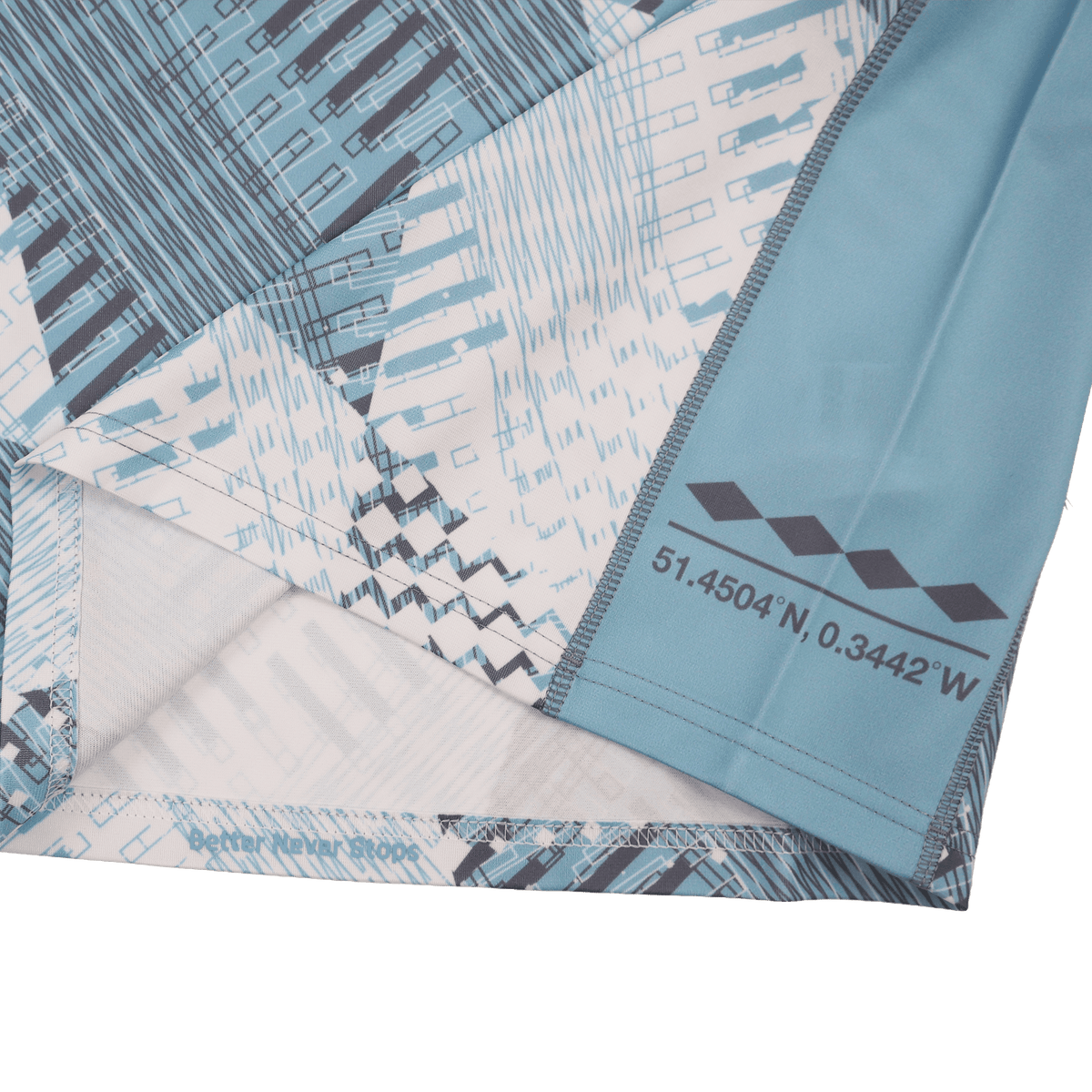 Close-up of the blue and white geometric fabric with printed coordinates—51.4504°N, 0.3442°W—from the Harlequins 22/23 Replica Away Jersey by Castore.