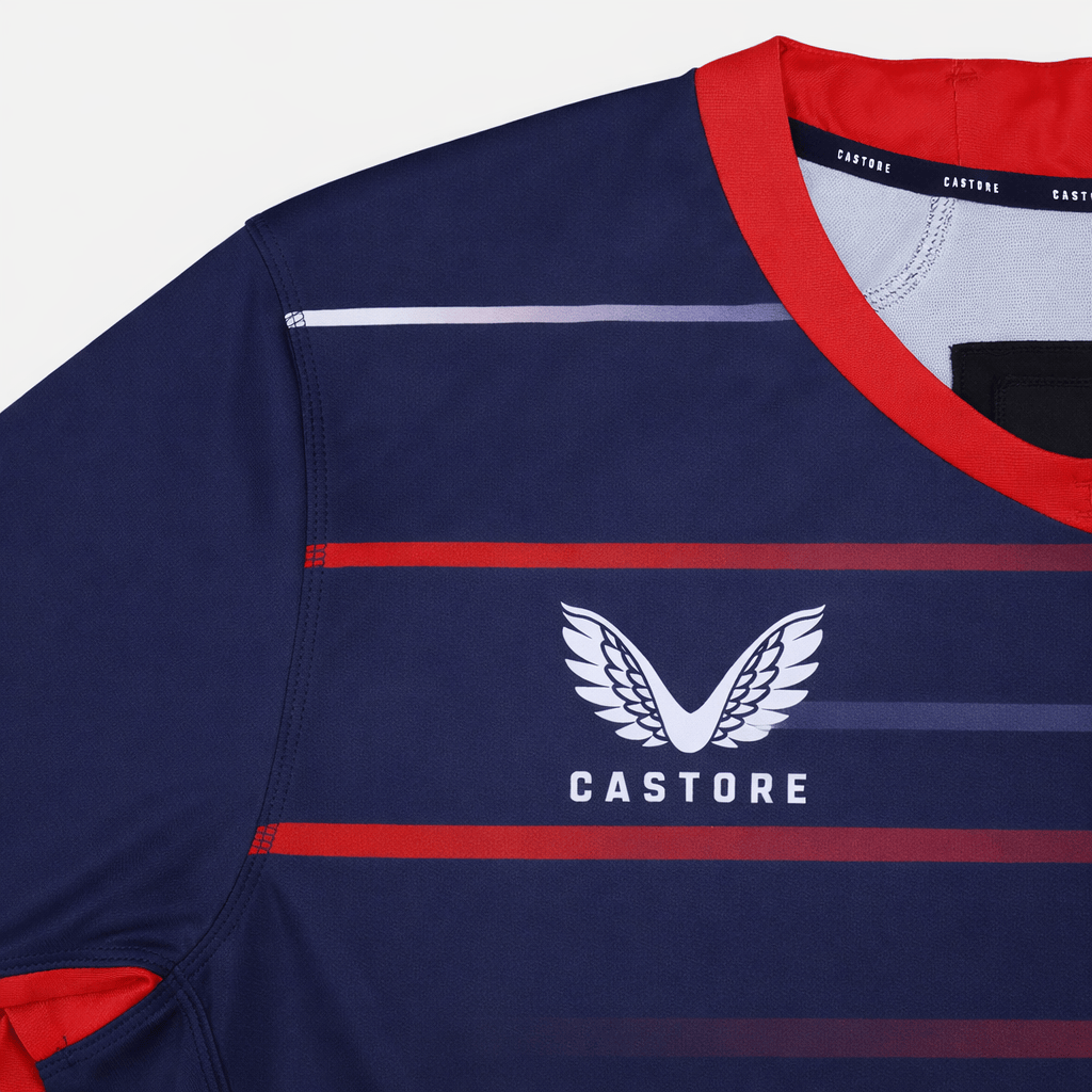 Close-up of the USA Rugby 22/23 Pro Away Jersey by Castore in navy with red and purple stripes, featuring the Castore logo and "Castore" text on the chest—a must-have for any USA Rugby fan.
