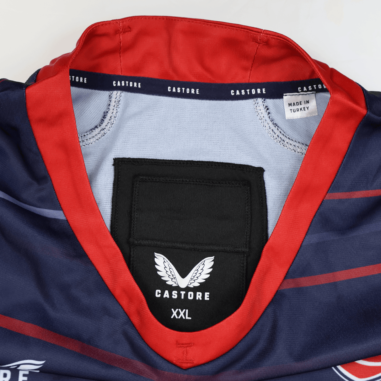 A close-up of the collar and inside label of the USA Rugby 22/23 Pro Away Jersey by Castore, featuring size XXL and a "Made in Turkey" tag.