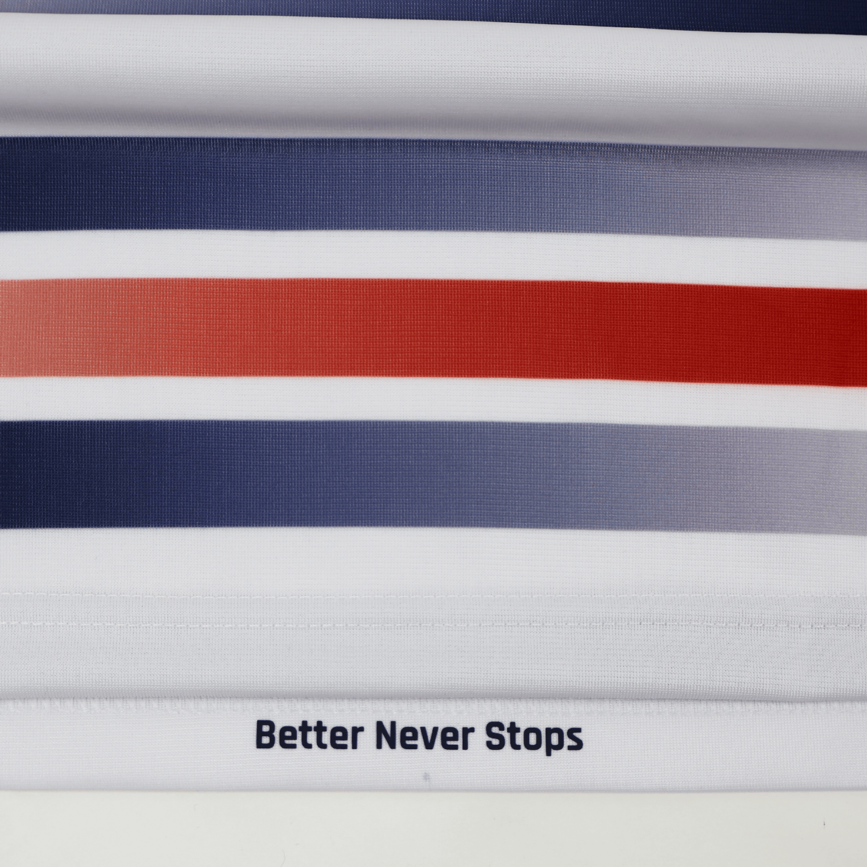 Horizontal stripes in blue, gray, and red with "Better Never Stops" at the hem, inspired by the Castore Women's USA Rugby Replica Home Jersey 22/23.