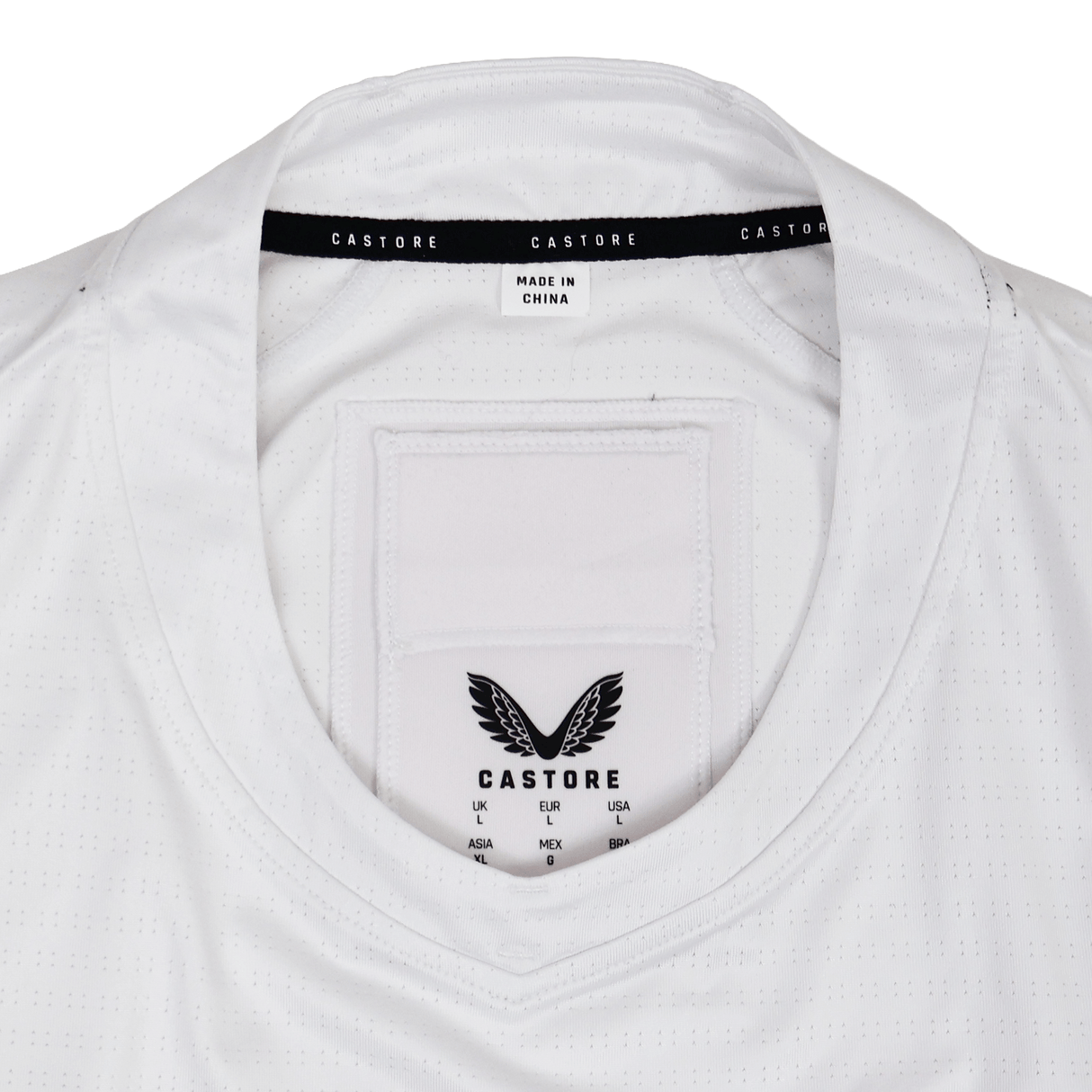 Close-up of the collar and inner labels on the USA Rugby 23/24 Training Jersey by Castore, featuring the Castore logo, size chart, and a "Made in China" tag.
