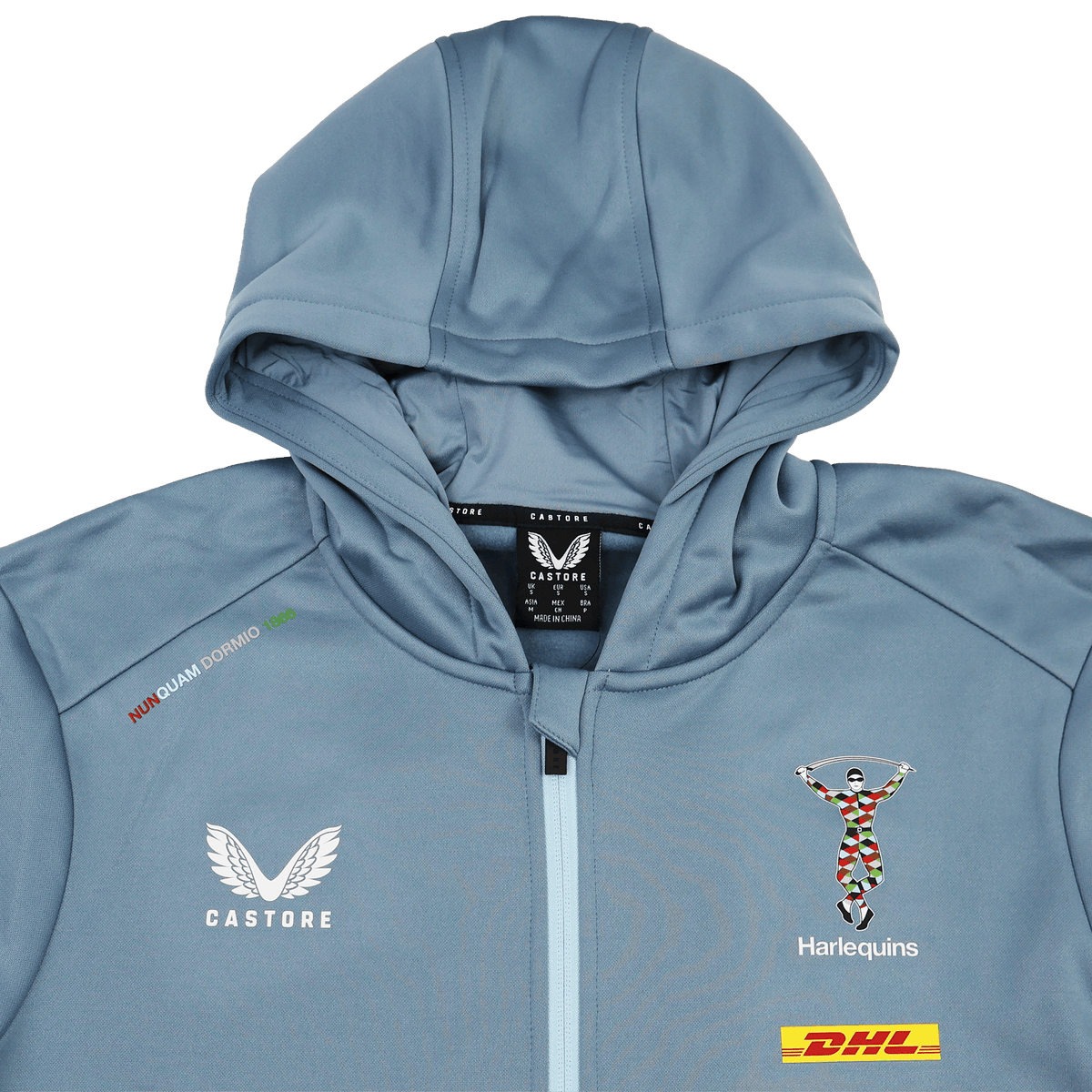 The Harlequins 23/24 Matchday Zip Through Hoodie by Castore features a light blue design, hood, DHL sponsor patch, and the iconic crest—official teamwear for Harlequins fans.