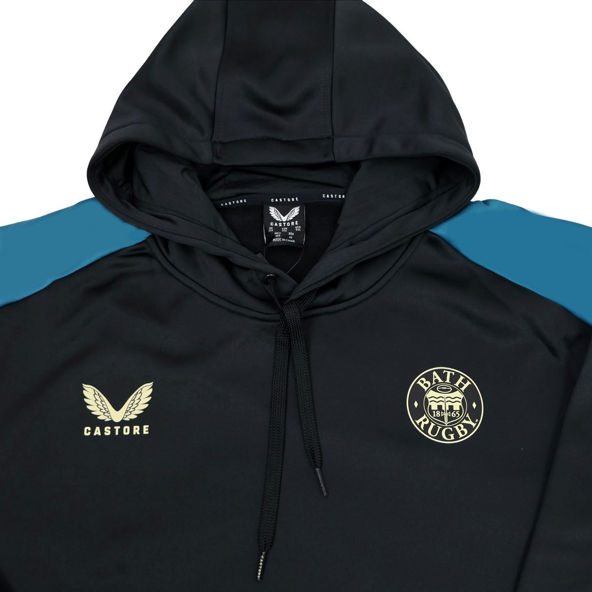 The Bath 23/24 Hoodie by Castore features a sleek black design with blue shoulder accents, a gold Bath Rugby logo on the chest, and a gold Castore logo. This stylish hoodie is perfect for dedicated fans.