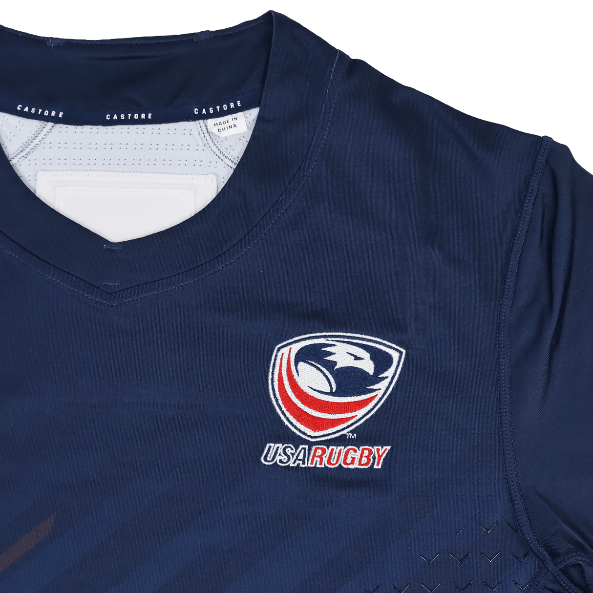 The USA Rugby 24/25 Pro Home Jersey by Castore features a navy blue design with the USA Rugby logo, eagle emblem on the chest, and signature Castore branding on the collar.