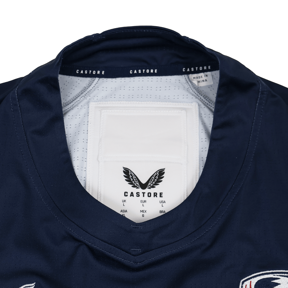 Close-up of the collar and neckline on the Castore USA Rugby 24/25 Pro Home Jersey, featuring inner tags and logo—an authentic detail from this official rugby jersey by Castore.