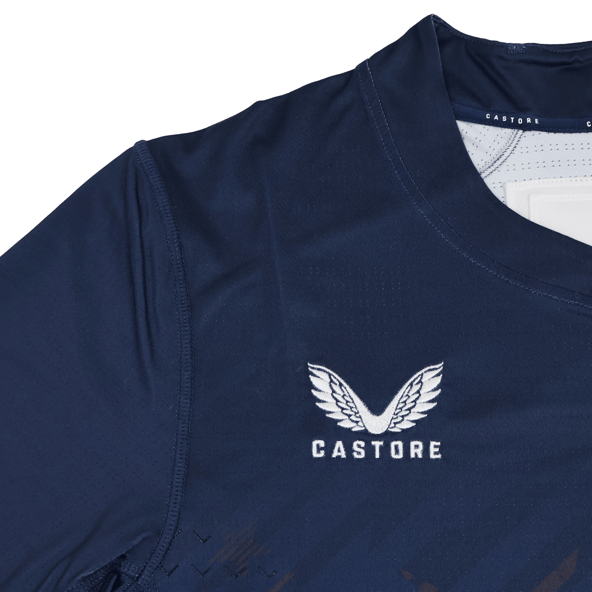 Close-up of the USA Rugby 24/25 7s Olympic Pro Home Jersey by Castore, in navy blue, featuring the Castore logo with white text and a wing design on the chest.