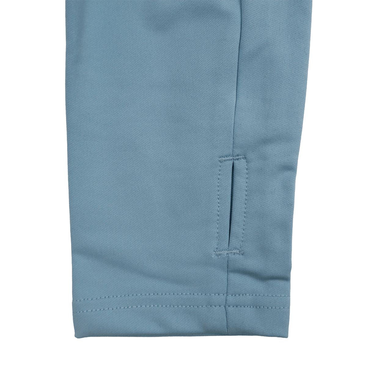Close-up of the bottom section of a blue pant leg with a small horizontal slit near the hem and visible stitching, ideal to pair with your Castore Harlequins 24/25 Matchday 1/4 Zip Midlayer.